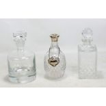 A cut glass decanter with silver collar and silver sherry bottle label (af) and two plain