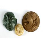 A 19th century vulcanite cameo plaque depicting profile bust of a female, 3 x 2.5cm, a green
