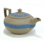 WEDGWOOD; an olive jasperware squat teapot with blue floral relief decoration, length 18.5cm.