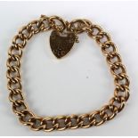 A 9ct yellow gold curb link bracelet with heart shaped padlock clasp, aperture approx 5.5 x 5.5cm,