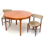 G-PLAN; a circular teak extending dining table, diameter when not extended approx 121cm, and two