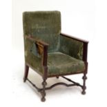 An Edwardian line inlaid and green upholstered enclose armchair raised on turned and block
