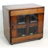 An early 18th century oak spice cabinet with geometrically moulded hinged door enclosing an