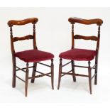 A pair of Victorian simulated rosewood bar back salon chairs raised on splayed front supports (2).