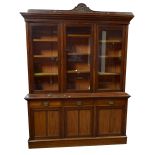A late Victorian mahogany bookcase, the moulded cornice above three glazed upper doors enclosing