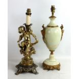 A gilt metal figural table lamp modelled as a seated cherub and an onyx table lamp with gilt metal