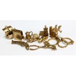A collection of charms with seven 9ct yellow gold examples including pistol, boat, teapot, etc,