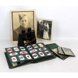 A small group of ephemera including an early 20th century cigarette card album, two black and