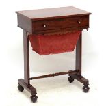 A Victorian mahogany sewing table with mother of pearl inlaid handles and sliding sewing box, raised