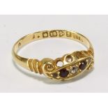 An Edwardian 18ct yellow gold, diamond and ruby dress ring, with five melee stones in foliate scroll