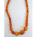 A graduated variously amber coloured bead necklace, length 53cm, approx 58.8g.