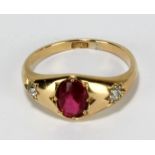 An 18ct yellow gold ring set with oval cut ruby, weighing approx 0.7ct, flanked by two round cut