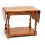 An oak dropleaf side table with undertier, 101 x 39.5cm when extended.