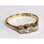 A yellow metal and diamond three stone ring stamped '18ct & PR80' to band interior, size I, approx