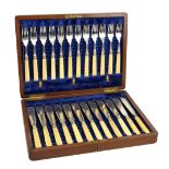 WALKER & HALL; a cased set of twelve George V hallmarked silver ivorine handled fish knives and