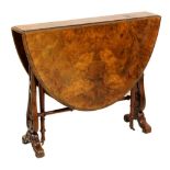 A Victorian burr walnut oval Sutherland table, raised on twin carved and pierced supports united
