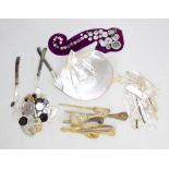 A group of mother of pearl items including pocket knife, gaming tokens, etc, also a carved horn