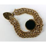 An early 20th century 9ct yellow gold graduated curb link bracelet suspending a swivel fob,