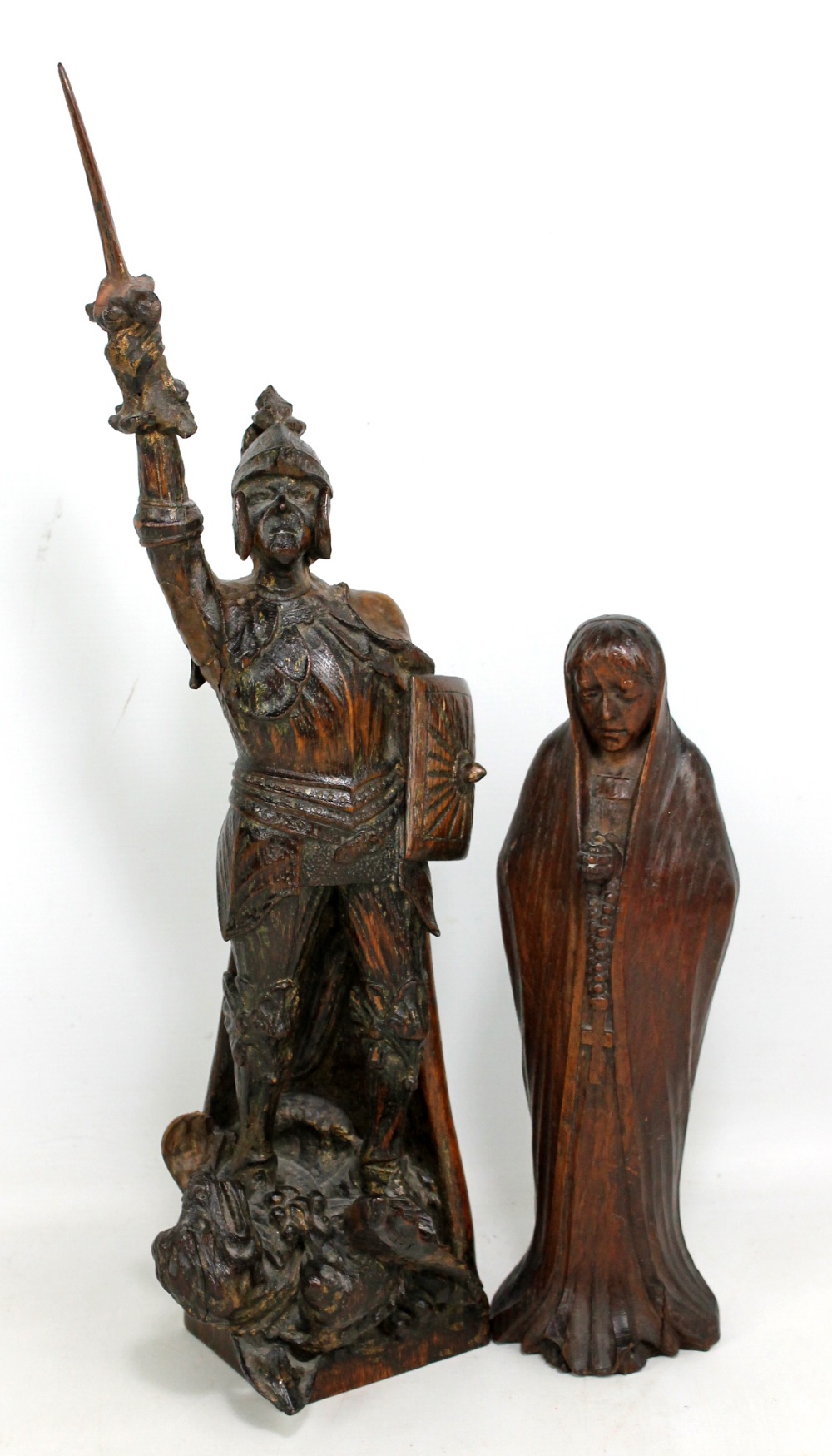 An early 20th century carved oak figure of St George and the Dragon, height 56.5cm, and a further