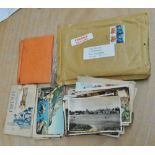 A small collection of postcards and stamps.