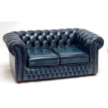 A blue leather Chesterfield two seater sofa.Additional InformationWould benefit from a clean, some