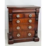 A Victorian mahogany miniature chest of drawers, the moulded rectangular top above frieze, two short