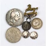 A George III crown, 1820, a 1917 George V shilling, two holed coins etc and a 'The Kings' badge.