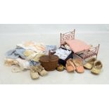 A doll's folding bed, doll's part dinner service and a group of doll's clothes including shoes.