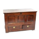 An 18th century oak blanket box with triple panel front above two drawers, on reduced stile