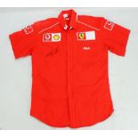 MICHAEL SCHUMACHER; a signed replica Ferrari shirt.Additional InformationThe shirt size is USA