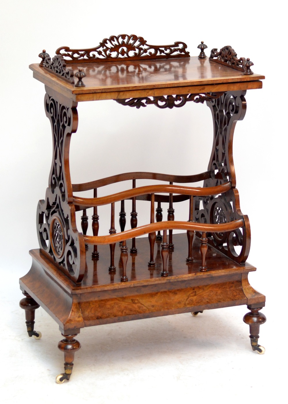 A Victorian burr walnut and walnut Canterbury whatnot with pierced end supports and single drawer to