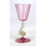 A Venetian goblet with pale mottled pink bowl, stylised clear glass dolphin column and pink tinted