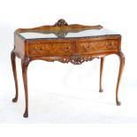 EPSTEIN; a walnut serpentine front serving table with two drawers on cabriole legs with carved