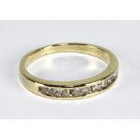 A 9ct yellow gold and diamond ring set with 9 round cut melee diamonds in channel setting, size O,