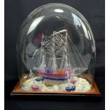 A spun glass model of a three masted ship with four smaller boats around the sides, mounted on a