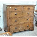 An early 19th century oak chest of two short and three long graduated drawers raised on bracket