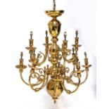 A large brass twelve branch chandelier and seven twin sconce wall lights (8).