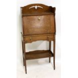 An early 20th century oak Arts and Crafts student's bureau, width 61cm.