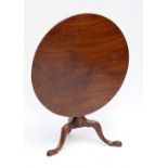 A George III mahogany circular tilt top occasional table on baluster column and tripartite base,