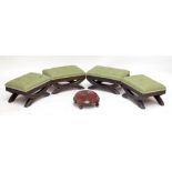 A set of four carved oak footstools with button padded upholstered tops and a beadwork decorated