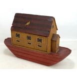 An early 20th century German painted wooden model Noah's Ark with partly hinged roof, length 56cm.