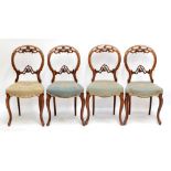 A set of four Victorian walnut balloon back salon chairs with floral woolwork upholstered seats