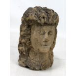 A carved stone female head, height 22.5cm (af).Additional InformationLoss to nose, rubbing to raised