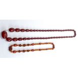 A cherry amber coloured graduated bead necklace, length 71cm, with screw clasp, and a further