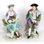 SITZENDORF; a pair of porcelain figures, lady holding tambourine with seated lamb and gentleman