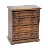 A small 20th century oak chest of four long drawers, width 62cm.Additional InformationHeight 71.5cm,