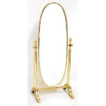 A 20th century brass cheval mirror on scrolling supports (for restoration), length 160cm.