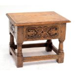 An early 20th century oak box with hinged lid and on stretchered supports, 43.5 x 33cm.