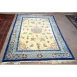 A large Chinese superwash carpet with stylised foliate decoration to cream and blue grounds,