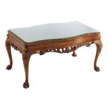 EPSTEIN; a walnut coffee table of serpentine outline with burr top on cabriole legs with carved